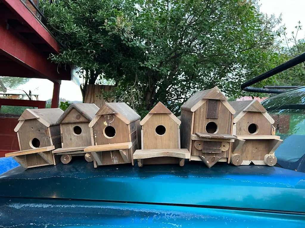 Row of handmade birdhouses built from reclaimed wood