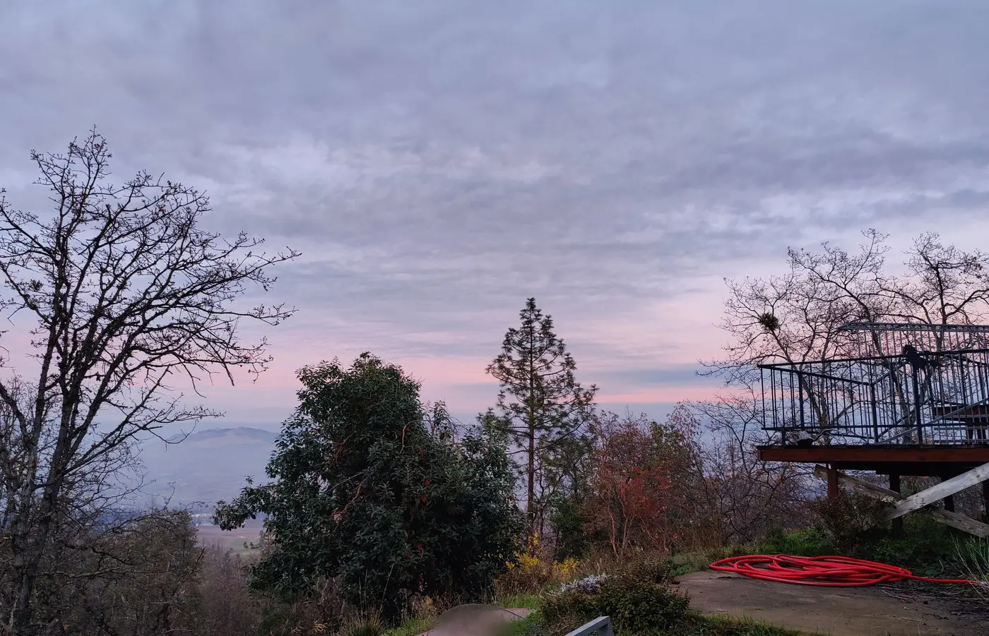 Pink dawn sky over the fog-filled valley