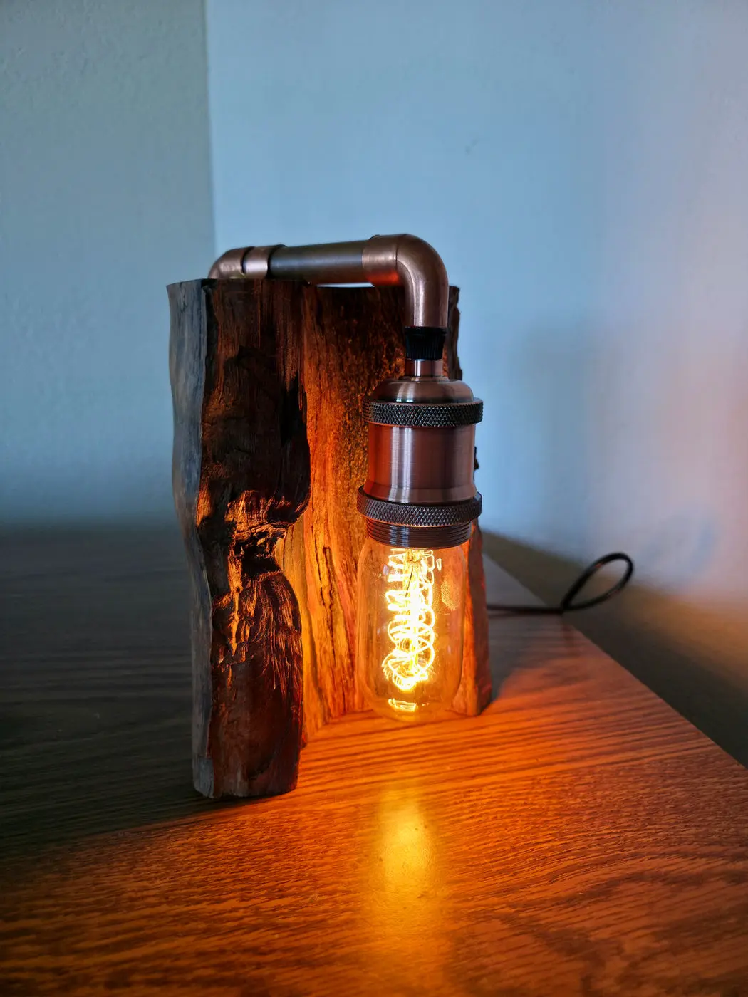 Madrone wood table lamp with an Edison bulb and copper pipe